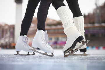 Fototapeta na wymiar Closeup skating shoes ice skating outdoor at ice rink