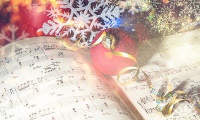 Red and blue christmas balls with golden ribbon on notes