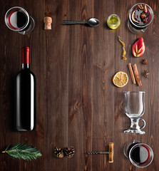 Mulled wine recipe ingredients and kitchen accessories, bottle of red wine, cinnamon, anise stars,...