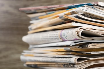 Pile of newspapers on white background