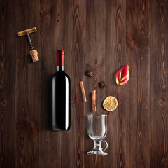 Mulled wine recipe ingredients and kitchen accessories, bottle of red wine, cinnamon, anise stars,...
