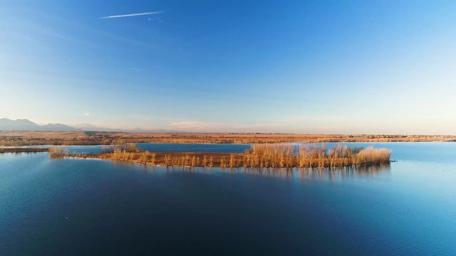 Aerial Pull Away From an Island in a Colorado Lake at Sunset