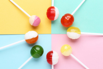 Sweet lollipops on colorful background