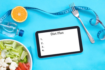 healthy eating, dieting, slimming and weigh loss concept - close up of diet plan on tablet pc screen.