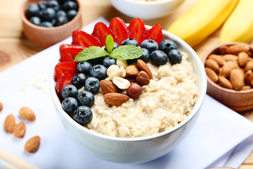 Oatmeal with berries and nuts in bowl