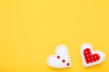 Fabric hearts on yellow background