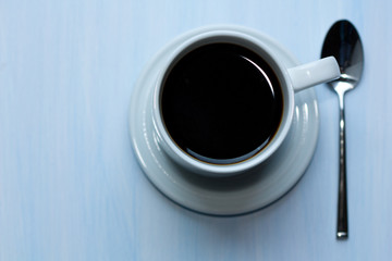 Cup of coffee on blue background.