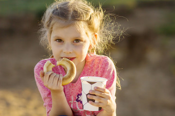 little girl eating doughnut