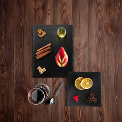 Mulled wine recipe ingredients and kitchen accessories, bottle of red wine, cinnamon, anise stars,...