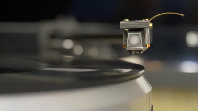 Vinyl record player. Needle headshell of turntable slow down on vinyl record rotating disco music. Classical music jazz records playing. DOF headshell bokeh. Hi-fi high end music concept close up