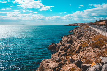 lone street on the right side next to the blue ocean