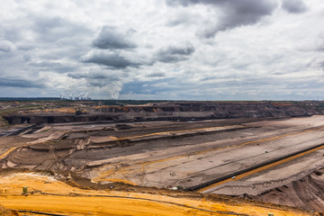 Kohl exit in Germany. Opencast mine in NRW. Open pit mining mega-machines like dump trucks the size...