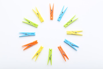 Colorful plastic clothespins on white background