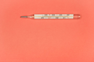 Medical mercury thermometer, Living Coral, trendy color 2019 background.  Free space for text.