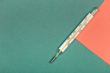 Medical mercury thermometer, Living Coral, trendy color 2019 background.  Free space for text.