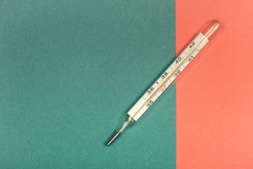 Medical mercury thermometer, Living Coral, trendy color 2019 background.  Free space for text.