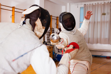 fencers at fencing workout, practicing attack movements