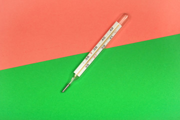 Medical mercury thermometer, Living Coral, trendy color 2019 background.  Free space for text.