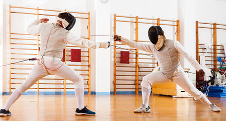 fencers at fencing workout, practicing attack movements