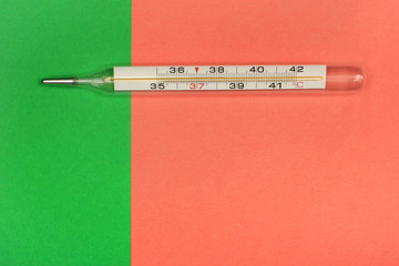 Medical mercury thermometer, Living Coral, trendy color 2019 background.  Free space for text.