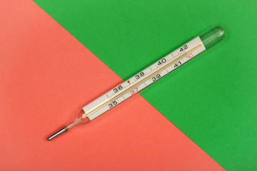 Medical mercury thermometer, Living Coral, trendy color 2019 background.  Free space for text.