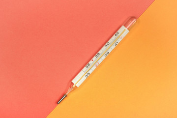 Medical mercury thermometer, Living Coral, trendy color 2019 background.  Free space for text.
