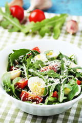 Salad with arugula leafs, tomatoes and eggs