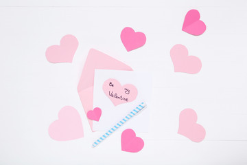 Inscription Be My Valentine with paper hearts and envelope on white background