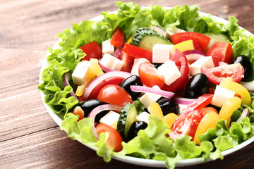 Vegetable salad in bowl on brown wooden table