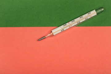 Medical mercury thermometer, Living Coral, trendy color 2019 background.  Free space for text.