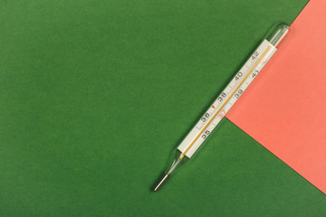 Medical mercury thermometer, Living Coral, trendy color 2019 background.  Free space for text.