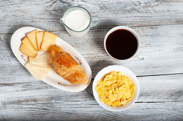 cup  coffee, muesli and  croissant on light background, healthy breakfast.