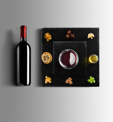 Mulled wine recipe ingredients and kitchen accessories, bottle of red wine, cinnamon, anise stars,...