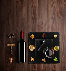 Mulled wine recipe ingredients and kitchen accessories, bottle of red wine, cinnamon, anise stars,...