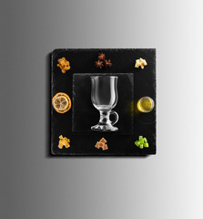 Mulled wine recipe ingredients and kitchen accessories, bottle of red wine, cinnamon, anise stars,...