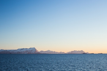 Sunset over the sea during the ferry trip to Lofoten islands (Norway) in winter