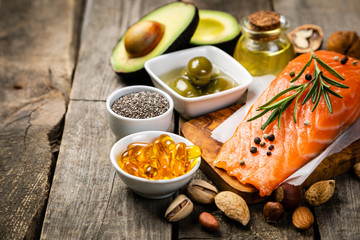Fototapeta Selection of healthy unsaturated fats, omega 3 - fish, avocado, olives, nuts and seeds obraz