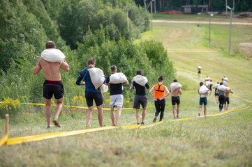 Obraz premium Men with bags on his shoulder are stage of track
