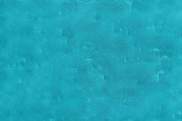 Chapped texture of an old scratched blue wall with turquoise reflections