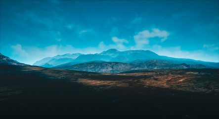 warm and cold colored mountains with high contrasted sky
