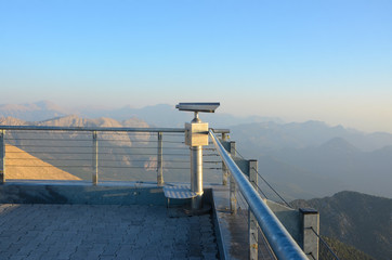 Dawn in the mountains. Telescope on the observation deck on top of the mountain.