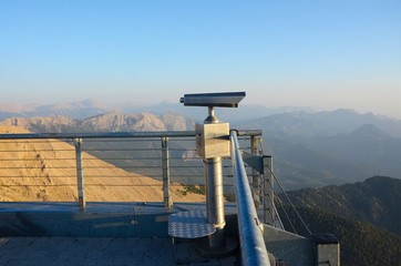 Dawn in the mountains. Telescope on the observation deck on top of the mountain.