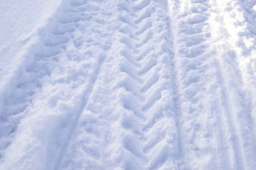 Fototapeta na wymiar Tracks in snow, texture of snow