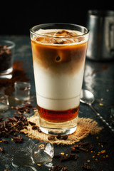 Delicious coffee with ice, caramel and cream