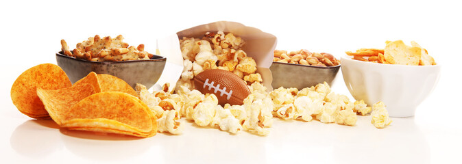 Chips, salty snacks, football on a table. Great for Bowl Game