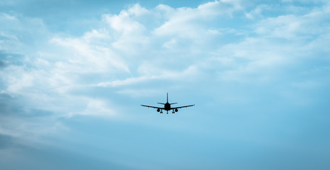 Fototapeta na wymiar Passenger jet flying into cloudly horizon