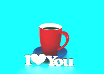 Valentines Day concept. Big red cup of coffee with stamp i love you on turquoise background. 