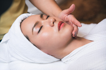 Beautiful young woman getting spa massage salon