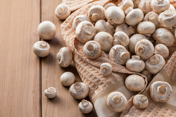 Fresh champignons on a wooden table.