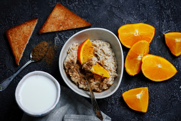 Oatmeal in to the bowl with orange.
